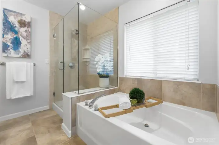 Bright, calming view of the primary bath with its frameless shower and separate tub - a perfect retreat. Bright, calming view of the primary bath with its frameless shower and separate tub - a perfect retreat.
