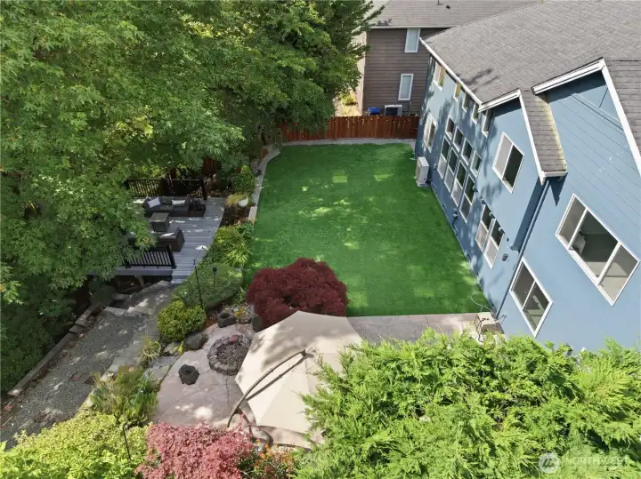 A sweeping aerial look at the garden reveals thoughtfully designed zones for play, outdoor dining, and peaceful relaxation. A sweeping aerial look at the garden reveals thoughtfully designed zones for play, outdoor dining, and peaceful relaxation.