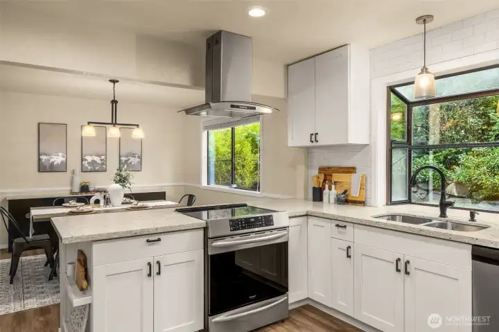 Sprawling quartz countertops, generous cabinetry, and views to the backyard.