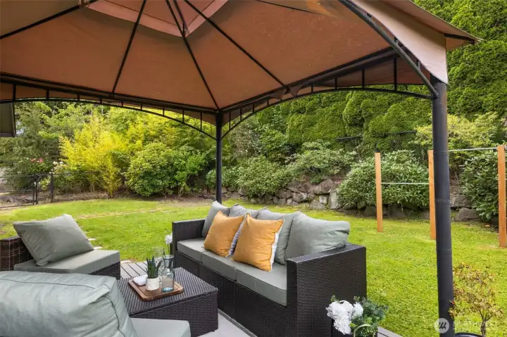Surrounded by mature landscaping, the backyard feels tucked away from the pace of the day.