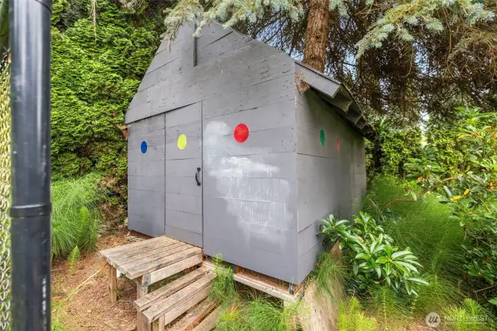A charming detached playhouse adds personality and possibility.