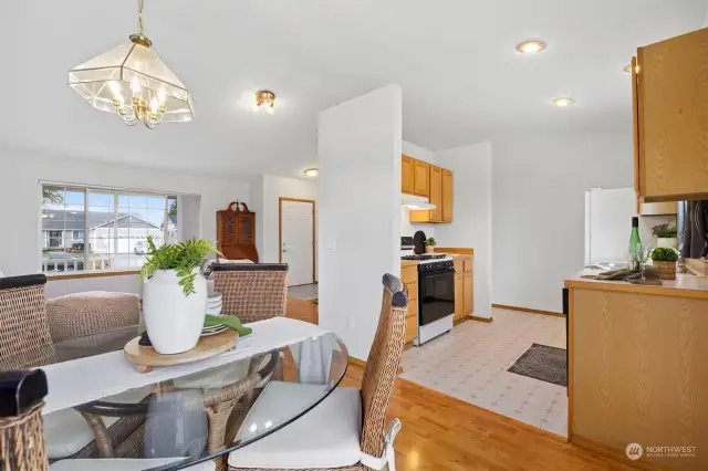 Looking across the dining room toward the living room with the entry beyond.