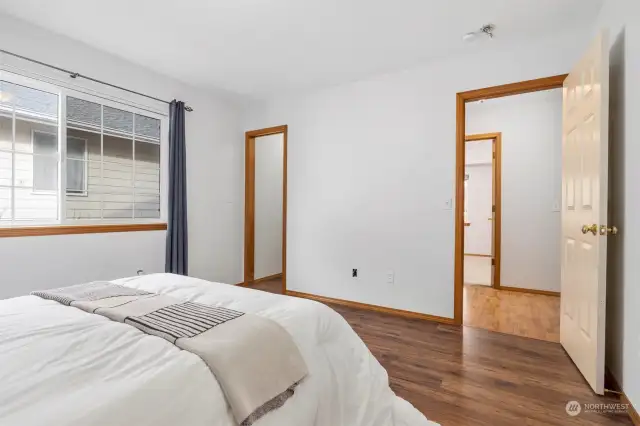 Looking across the primary bedroom with the walk-in closet on the left and another bedroom across the hall.