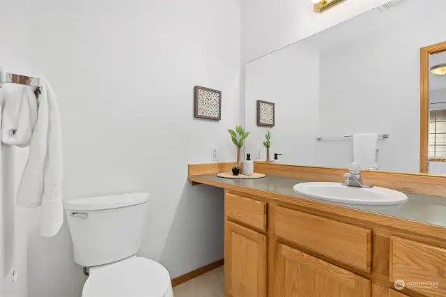 The primary bath does have a large vanity and a space for a hamper.