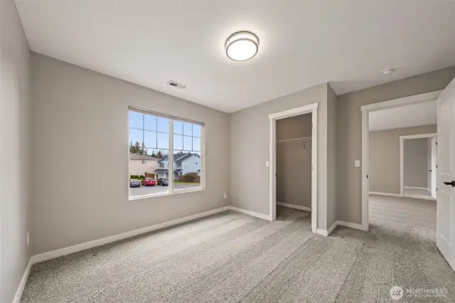 Bedroom # 3 overlooks the front of the home & features a walk-in closet.