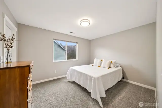 Bedroom # 5 overlooks the side of the home & features a walk-in closet.
