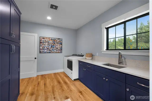 Huge laundry room with pantry. This area leads into the finished shop space.