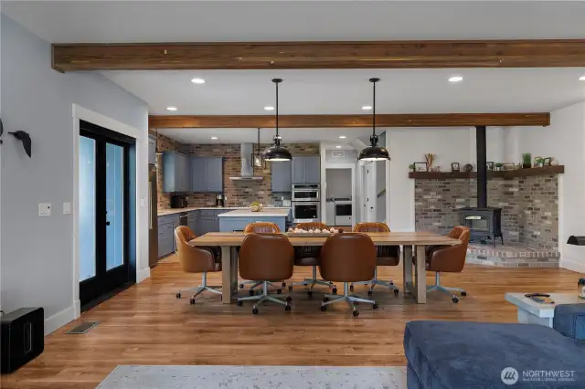 Dining area and wood fireplace. Ceiling showcasing wood beams!