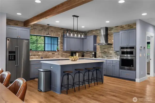 Kitchen has Honed Quartz counters, beautiful cabinets and window looking out at the beach pine.