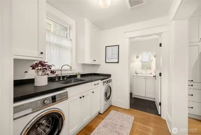 Spacious mudroom/laundry off the kitchen has tons of counterspace.  A powder bath is conveniently tucked away in the back.