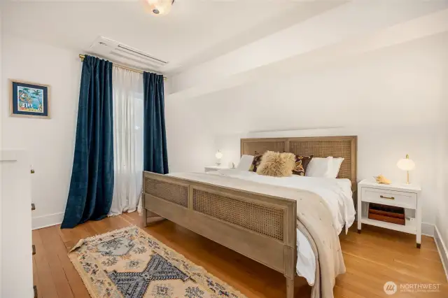 Luxurious primary bedroom with ensuite bath and walk-in closet feel like a premium boutique hotel room.