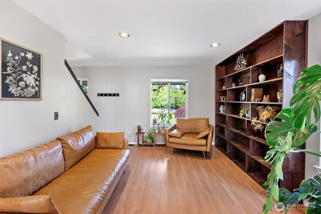 Cozy living room off the entrance with bookcase wall for all your favorite things