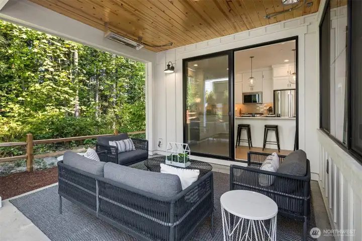 Covered back patio with forest backdrop.