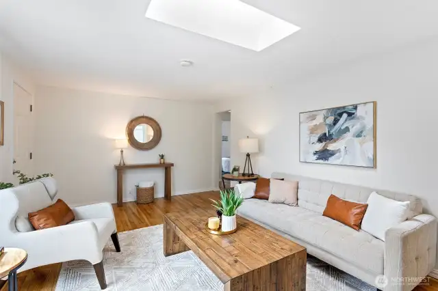 Freshly painted, the living room has oak flooring and a large footprint to accommodate various designs.