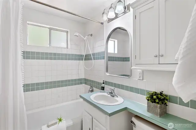 Main floor bathroom with new mirror and new flooring.