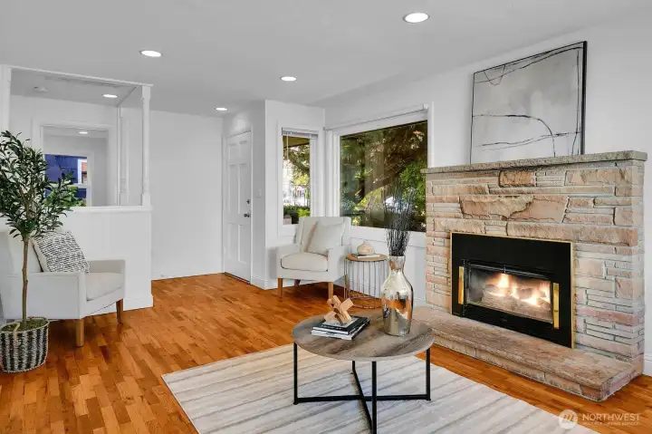 Hardwood floors and recessed lighting in entry and living room