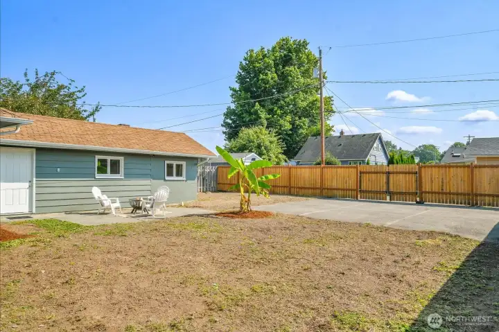 Level, fenced back yard with parking area and alley access