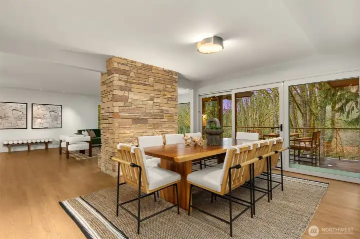 The fireplace grounds the dining area with its rich, textured presence.