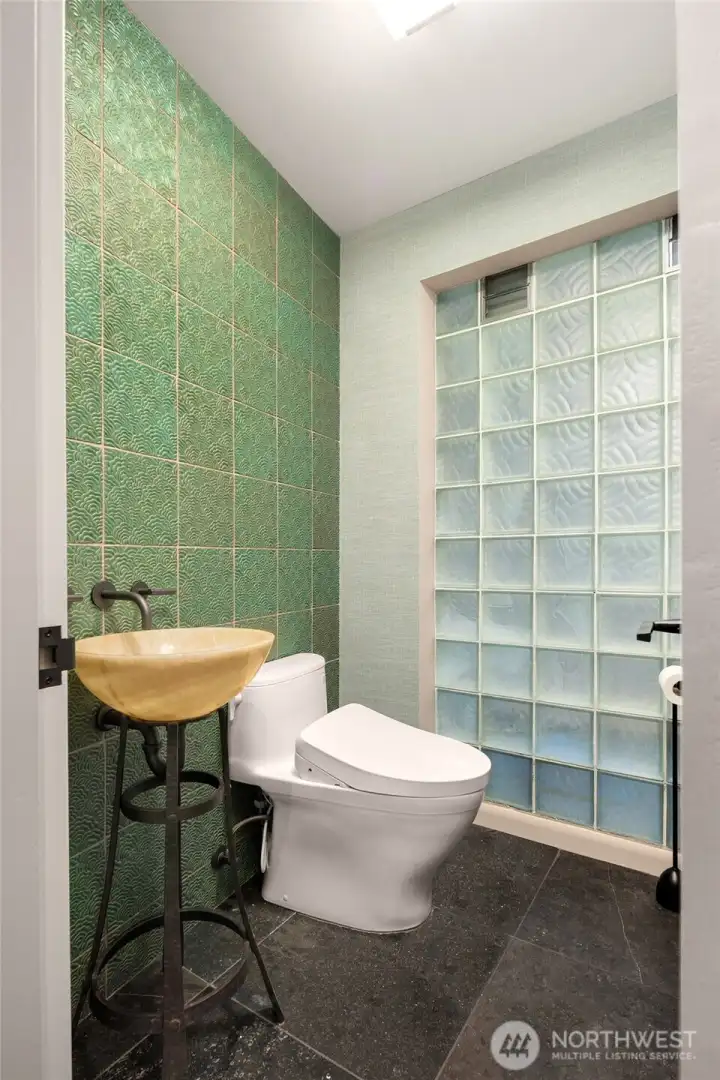Powder room adorned with Ann Saks Chinois style tile.