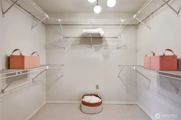 Primary suite walk-in closet. There is an additional large closet in the vanity area of the primary bath.