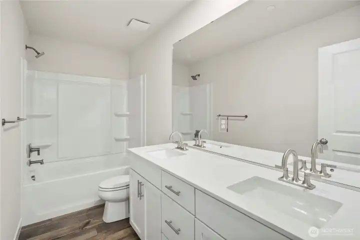 Upstairs bath. Photos of a previously completed home. Actual colors and finishes may vary. See site agent for details.