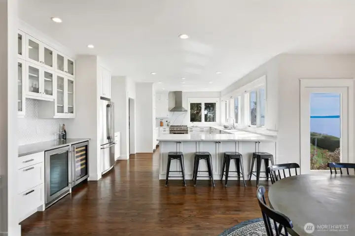 Chef's kitchen with island seating and expansive views.
