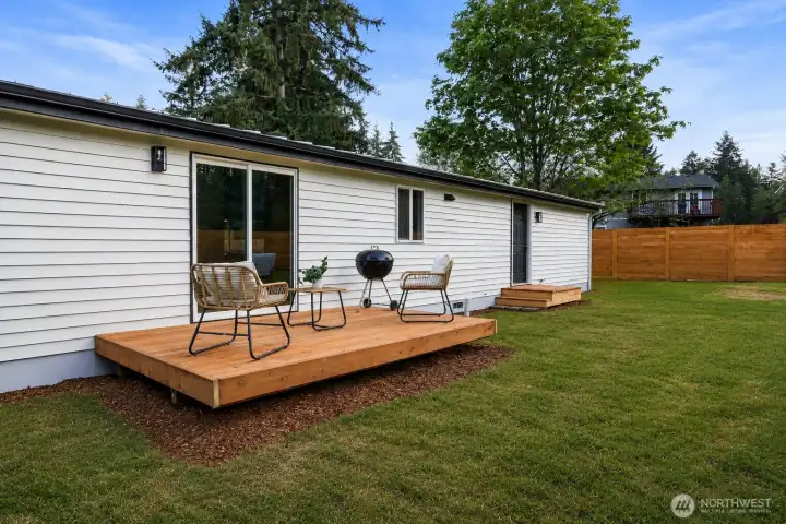 Decking overlooking yard. Perfect for relaxing in the sun or grilling!