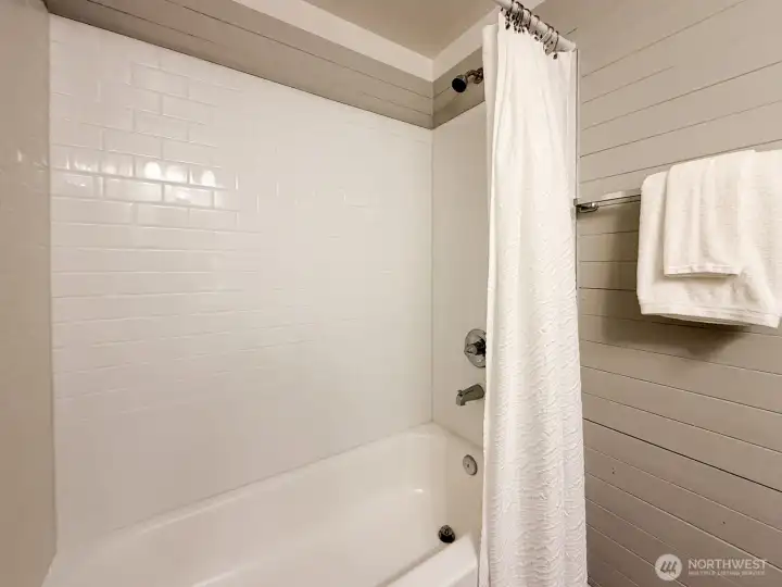 Upstairs bathroom with tub and shower