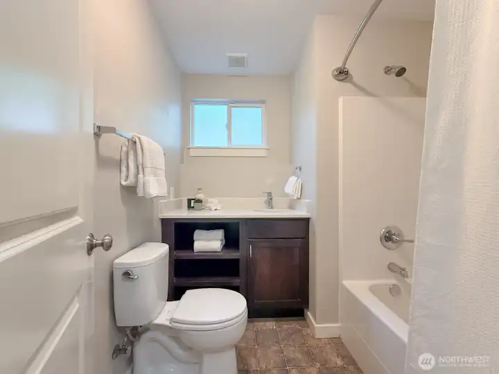 Downstairs bathroom with tub and shower