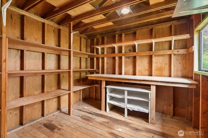 Shed with electricity, work bench built-in shelving.