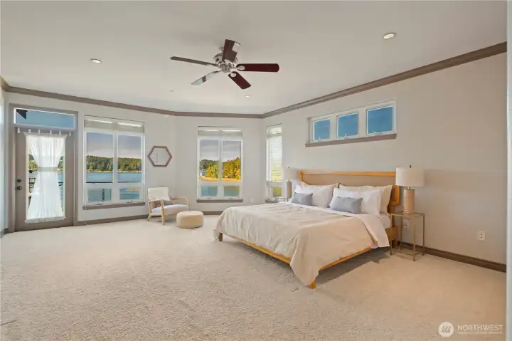 Fall asleep and wake every day to this stunning view. The generously proportioned main floor primary suite makes this king-size bed feel surprisingly small.