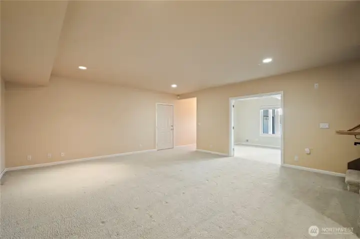 Downstairs rec room offers double door entry into guest bedroom 3. Hallway leads to lower shop and 2 car garage. Door on the left opens to massive crawlspace with potential to be finished in the future.