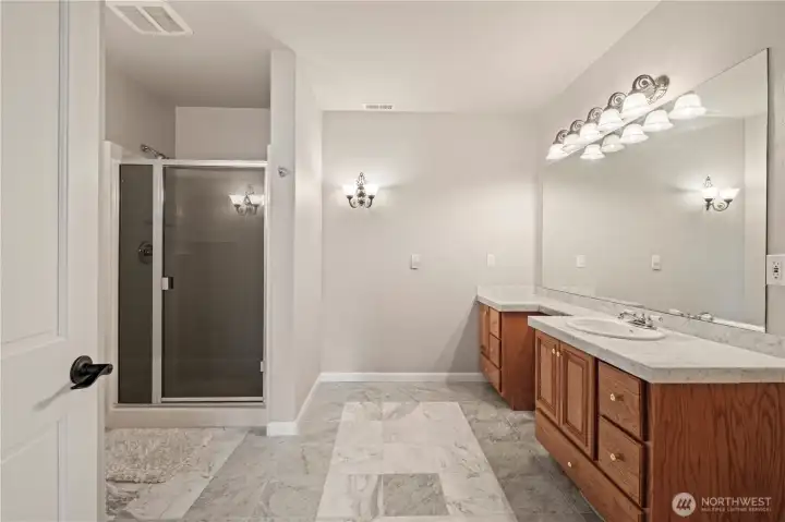 Large downstairs bathroom accessible from the hallway and private door to the 2nd primary suite.