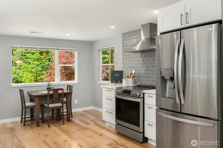 Spacious Chef's Kitchen with Stainless Steel Appliances, Custom Tile, Electric Range