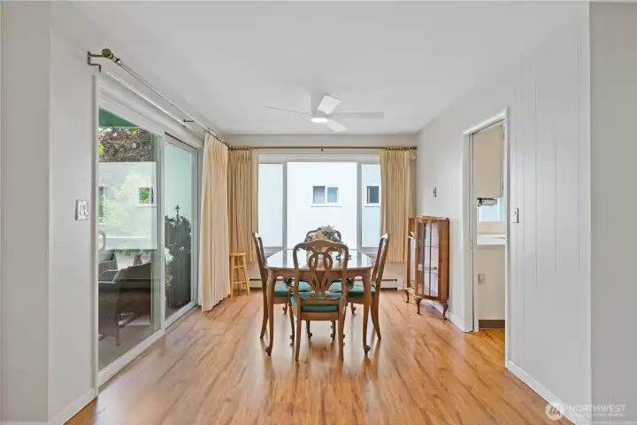 Airy dining room with slider to patio overlooking Vandercook park.