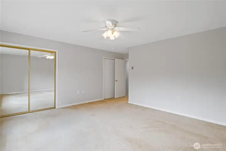 Primary bed with two closets and view of the park.