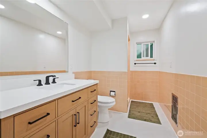 Updated bath with large vanity, new floors, fresh paint and new lighting