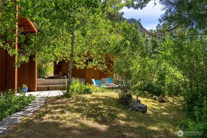 The entry courtyard features built-in bench seating and the detached gear shed and workshop. The entry courtyard features built-in bench seating and the detached gear shed and workshop.