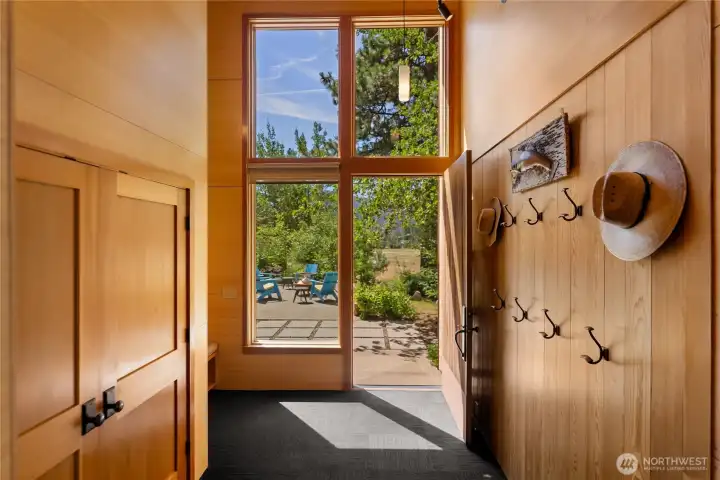 The double-height entry is light-filled and features a boot bench, storage cubbies and a large coat closet The double-height entry is light-filled and features a boot bench, storage cubbies and a large coat closet