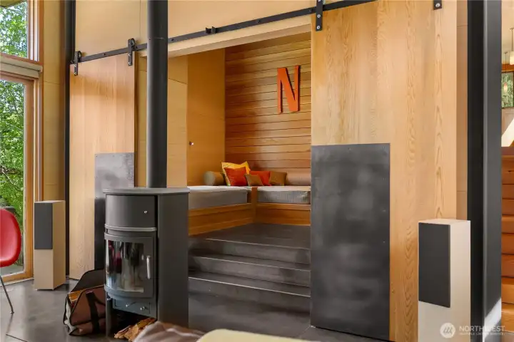 Custom steel stairs lead from the living room to the Nest - a cozy den that doubles as a guest room. Custom steel stairs lead from the living room to the Nest - a cozy den that doubles as a guest room.