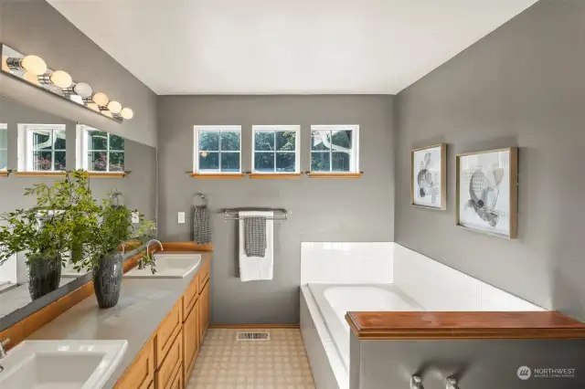 Primary en suite bath features soaking tub, double vanity and shower (out of view).