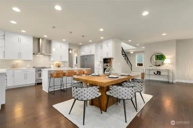 Beautiful flooring throughout main level. This view looks back to entry and hall with main level bedroom + 3/4 bath.