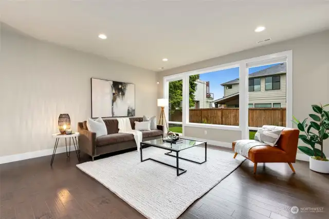 Large windows overlook spacious back yard.