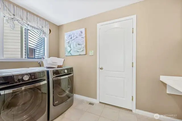 Utility/mud room with tile floors and custom cabinets
