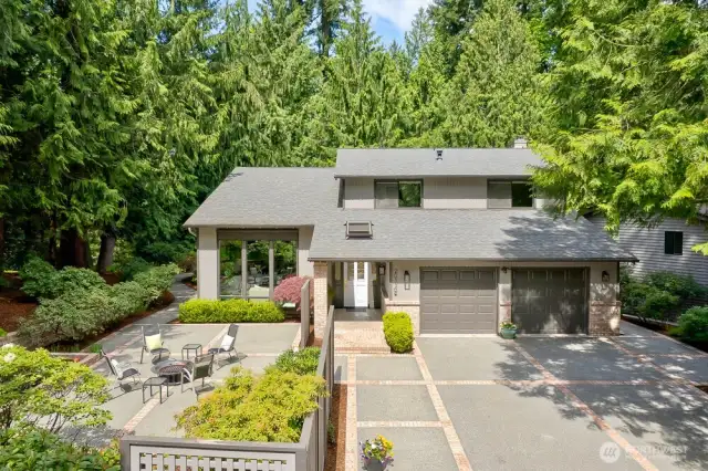 Custom driveway with brick inlays, ligh standards and water feature compliments this beautiful 2 story home