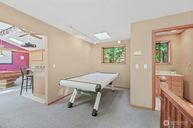 Detached game room and bathroom with shower, sink, and toilet