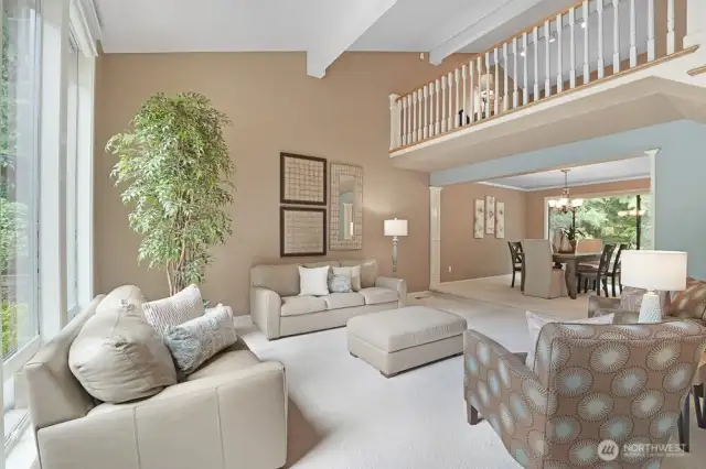 Formal living room with vaulted ceiling as well as floor to ceiling windows