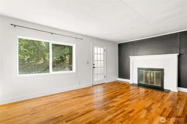 Primary bedroom with fireplace and access to main floor deck
