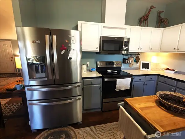 Kitchen with glass top range & built-in dishwasher. Fridge stays with full price offer.