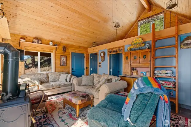 Main living room with charming loft with a warm inviting ambiance.